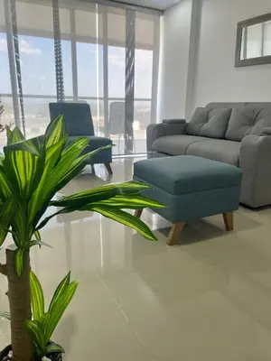 a living room with a couch and a chair and a plant at Sunny House in Cartagena de Indias