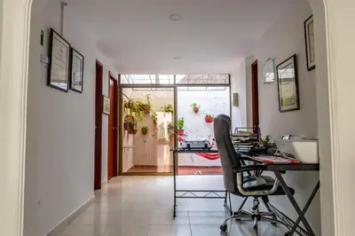 a hallway with a desk and chairs in a room at ORESCA Hostel in Cartagena de Indias