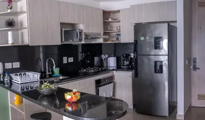 a kitchen with a stainless steel refrigerator and cabinets at Lujoso Apartamento en Bocagrande in Cartagena de Indias