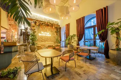 a restaurant with tables and chairs in a room at Hotel Voilá Centro Histórico in Cartagena de Indias