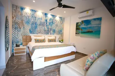 a bedroom with a bed and a couch at Hotel Poblado Coveñas in Coveñas