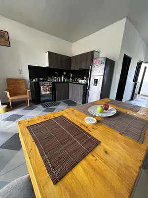 a kitchen with a wooden table with a plate of fruit on it at Amiri in Puerto Colombia