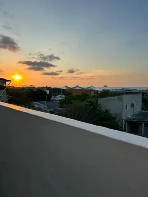 a view of the sunset from the roof of a building at Amiri in Puerto Colombia