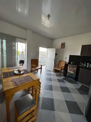 a living room with a table and a kitchen at Amiri in Puerto Colombia
