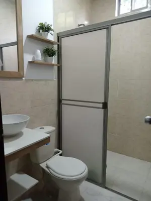 a bathroom with a shower and a toilet and a sink at zara's apartamento en coveñas in Coveñas