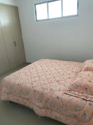 a bed in a white room with a window at Apartamento con balcon y vista al mar en Coveñas in Coveñas
