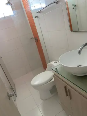a bathroom with a toilet and a sink and a mirror at Apartamento con balcon y vista al mar en Coveñas in Coveñas