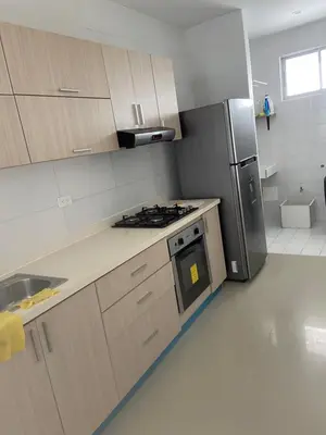 a kitchen with a stove and a refrigerator at Apartamento con balcon y vista al mar en Coveñas in Coveñas
