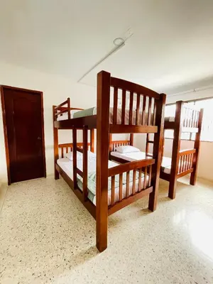 two bunk beds in a room with a door at MADILI DEL MAR in Santiago