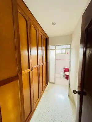 a hallway with wooden cabinets and a bathroom at MADILI DEL MAR in Santiago