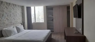 a hotel room with a bed and a television at Eslait Hotel & Apartamentos in Barranquilla