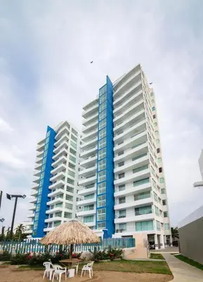 two tall buildings with tables and chairs in front of them at Magico Apartamento Frente al Mar 3 Habitaciones PAZ151 in Coveñitas