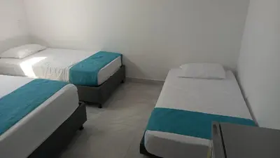 two beds in a room with twoperate beds at Sky view hotel tolu in Tolú