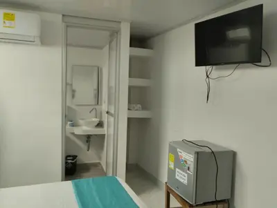 a room with a bed and a tv on the wall at Sky view hotel tolu in Tolú