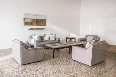 three chairs and a coffee table in a living room at Polanco Residences Tocagua Cartagena - Colombia in Cartagena de Indias