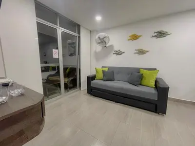 a living room with a couch with yellow pillows at Polanco Residences Tocagua Cartagena - Colombia in Cartagena de Indias