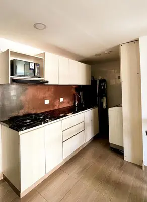 a kitchen with white cabinets and a stove top oven at Polanco Residences Tocagua Cartagena - Colombia in Cartagena de Indias