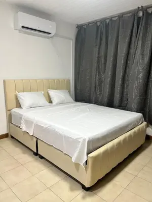 a bedroom with a bed with white sheets and a heater at Espetacular vista mar y playa in Cartagena de Indias