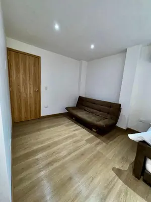 a living room with a couch and a wooden floor at SUNSET BEACH in Playa Blanca