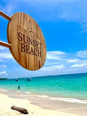 a beach with a sign that reads sunset beach at SUNSET BEACH in Playa Blanca