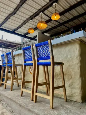 a row of blue chairs sitting on a patio at SUNSET BEACH in Playa Blanca