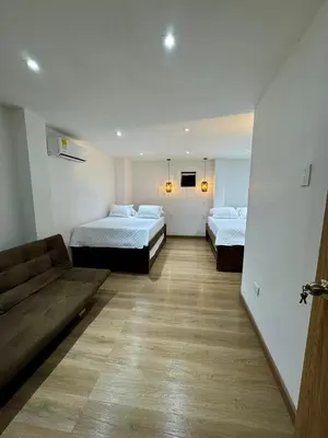 a hotel room with two beds and a couch at SUNSET BEACH in Playa Blanca