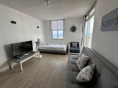 a living room with a couch and a bed at Vista al Mar Fragata Style in Cartagena de Indias