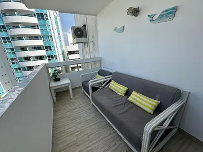 a living room with a couch and a balcony at Vista al Mar Fragata Style in Cartagena de Indias