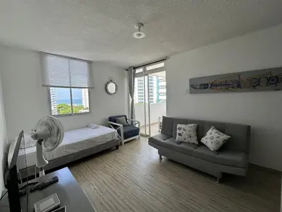 a living room with a couch and a fan at Vista al Mar Fragata Style in Cartagena de Indias