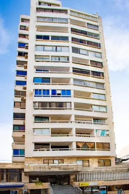 a tall white building with many windows at Vista al Mar Fragata Style in Cartagena de Indias