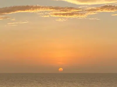 a sunset over the ocean with the sun in the sky at Vista al Mar Fragata Style in Cartagena de Indias