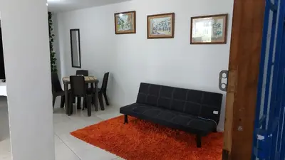 a black couch in a living room with a table at Hogar dulce hogar in Cartagena de Indias