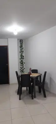 a table and chairs in a room with a plant on the wall at Hogar dulce hogar in Cartagena de Indias