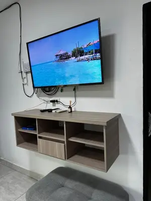 a flat screen tv sitting on top of a tv stand at Cabaña pescador de colores in Coveñas