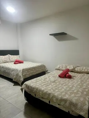 two beds in a room with red pillows on them at Cabaña pescador de colores in Coveñas