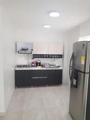 a kitchen with a stainless steel refrigerator in it at Cabaña pescador de colores in Coveñas
