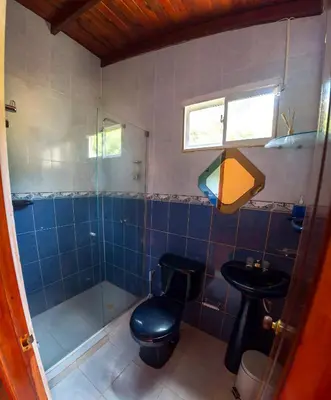 a bathroom with a shower and a toilet and a sink at Portoazul Casa de Playa in Puerto Colombia