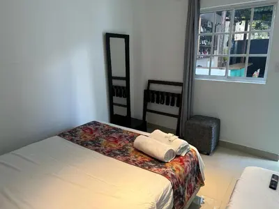 a bedroom with a bed and a window at Hotel CastilloMar in Cartagena de Indias