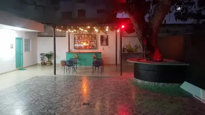 a room with a tree and a table with chairs at Hotel CastilloMar in Cartagena de Indias