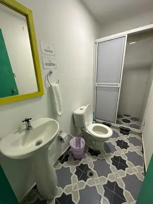 a bathroom with a toilet and a sink at Hotel CastilloMar in Cartagena de Indias