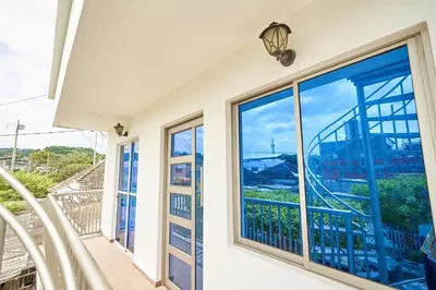 a balcony with large windows and a view of the city at Passarela Hospedaje in Cartagena de Indias