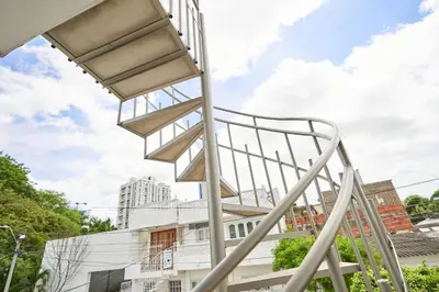 a metal staircase in front of a building at Passarela Hospedaje in Cartagena de Indias
