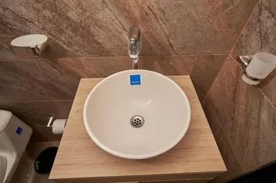 a bathroom with a white sink on a wooden counter at Passarela Hospedaje in Cartagena de Indias
