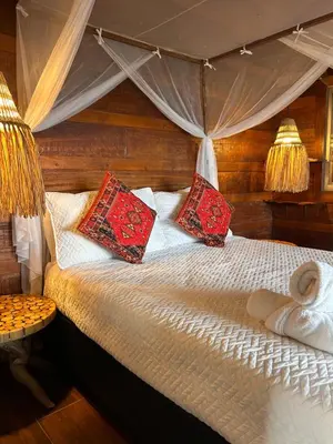 a bedroom with a bed with red pillows at Kite Eco House Salinas del rey in Salina de Rey