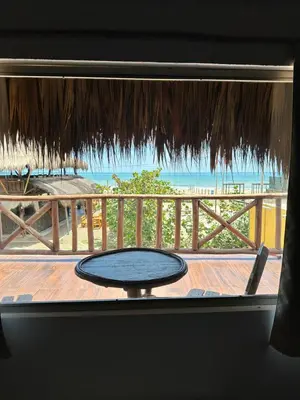 a table on a balcony with a view of the ocean at Kite Eco House Salinas del rey in Salina de Rey