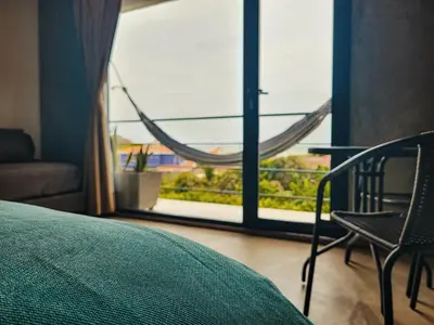 a bedroom with a bed and a window with a hammock at BREES in Santa Veronica