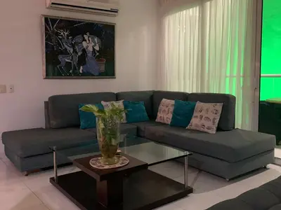 a living room with a couch and a table at Morros 3 - Vista y salida directa al mar in Cartagena de Indias
