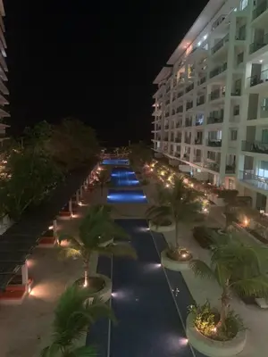 a hotel courtyard at night with palm trees and lights at Morros 3 - Vista y salida directa al mar in Cartagena de Indias