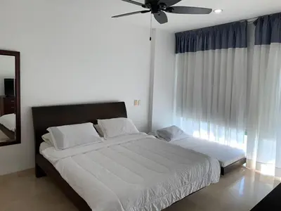 a bedroom with a large bed with a ceiling fan at Morros 3 - Vista y salida directa al mar in Cartagena de Indias