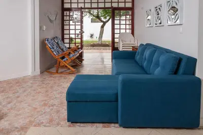 a living room with a blue couch and a chair at Hermosa Cabana con Piscina 3 Habitaciones MC21 in Coveñitas